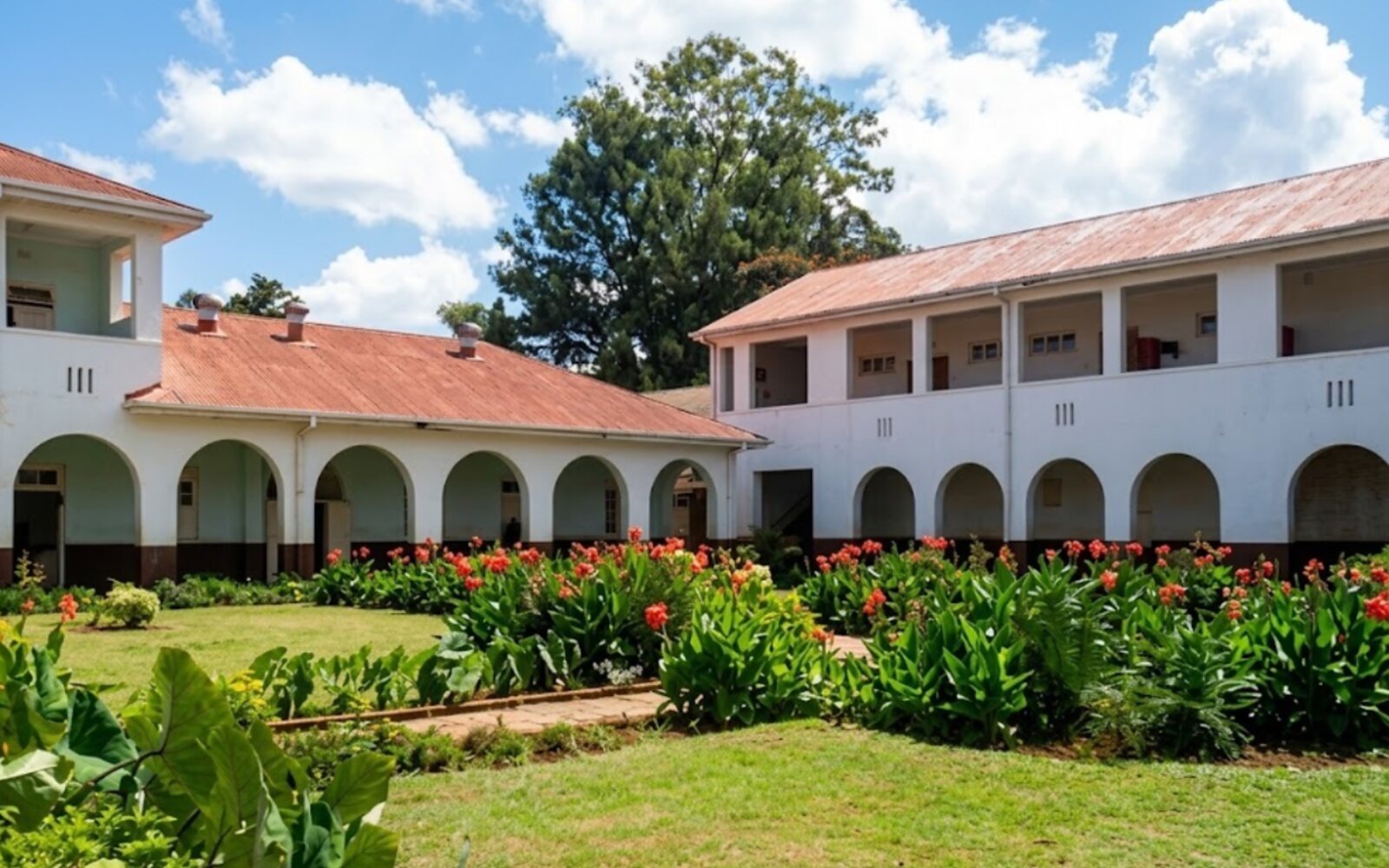 Red cannas along the arcade of the inner courtyard.